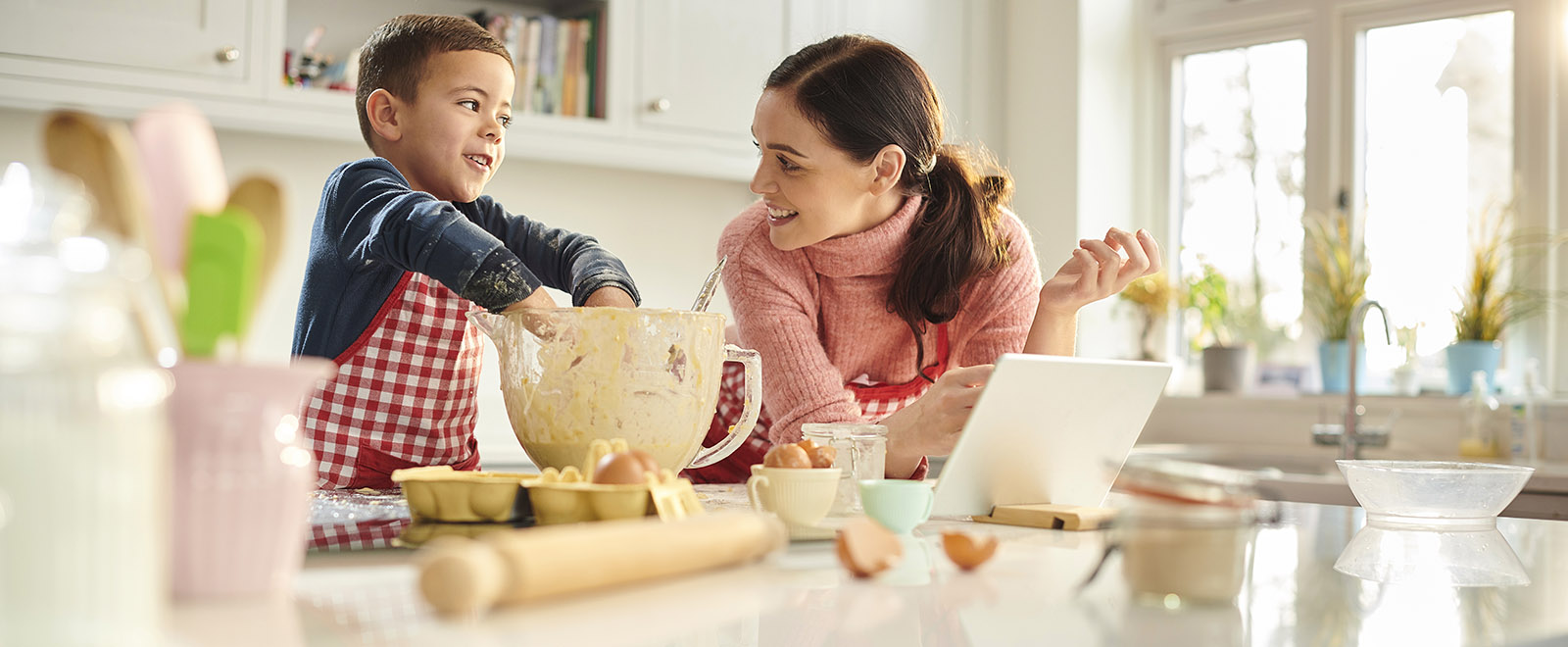 IMAGE: Mother in kitchen with young child making cookies