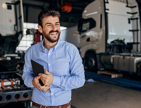 IMAGE: a man smiling in a truck shop