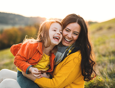 IMAGE: a mom and daughter playing and smiling