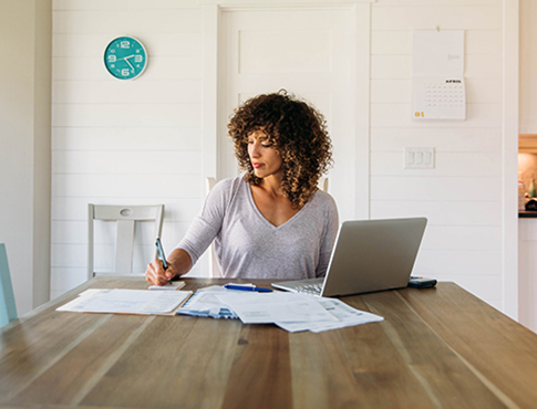 IMAGE: woman working at her kitchen table