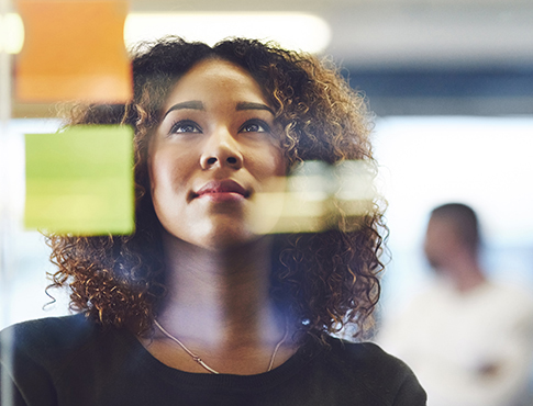 IMAGE: a woman looking at a vision board