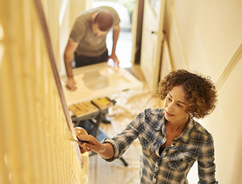 IMAGE: a man and a woman making home renovations